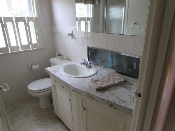 54 Endecott Street Springfield, MA 01118 - Photo 14 of 23 a bathroom with a granite countertop sink a toilet and a mirror