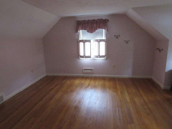 54 Endecott Street Springfield, MA 01118 - Photo 15 of 23 an empty room with wooden floor and windows
