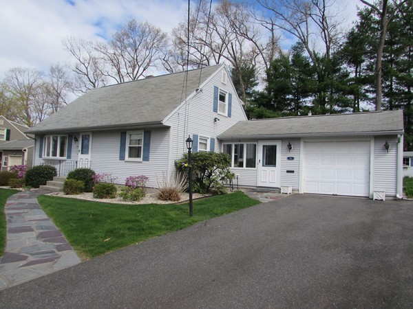 54 Endecott Street Springfield, MA 01118 - Photo 2 of 23 a front view of a house with a yard and garage