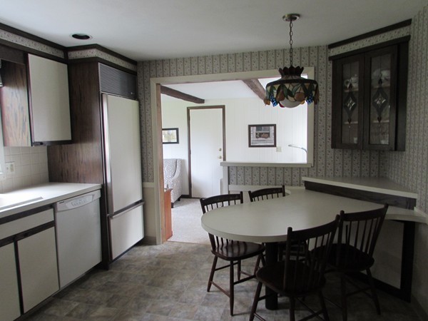54 Endecott Street Springfield, MA 01118 - Photo 4 of 23 a kitchen with stainless steel appliances granite countertop a dining table chairs and a refrigerator