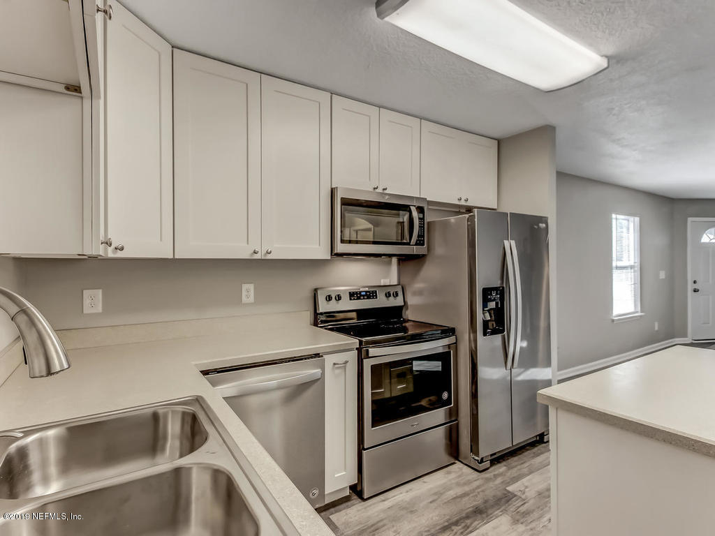 2165 Tuskegee Road Jacksonville, FL 32209 - Photo 12 of 32 a kitchen with a refrigerator stove and sink