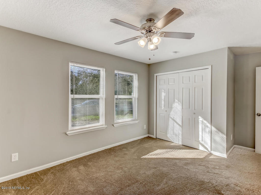 2165 Tuskegee Road Jacksonville, FL 32209 - Photo 17 of 32 an empty room with windows and fan
