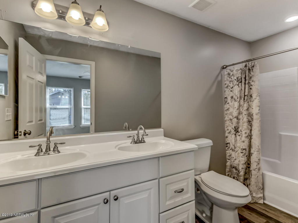 2165 Tuskegee Road Jacksonville, FL 32209 - Photo 20 of 32 a bathroom with a sink toilet and a mirror