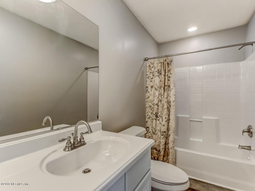 2165 Tuskegee Road Jacksonville, FL 32209 - Photo 21 of 32 a bathroom with a sink a toilet and shower