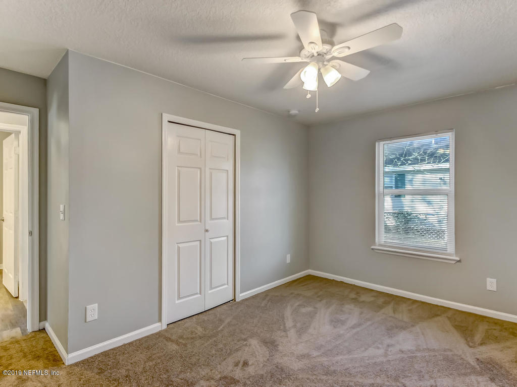 2165 Tuskegee Road Jacksonville, FL 32209 - Photo 25 of 32 an empty room with windows and fan