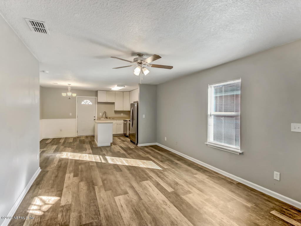2165 Tuskegee Road Jacksonville, FL 32209 - Photo 7 of 32 a view of a livingroom with a chandelier fan and a window