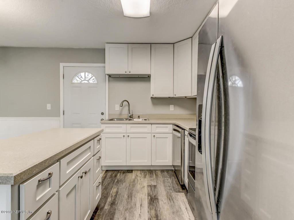 2165 Tuskegee Road Jacksonville, FL 32209 - Photo 8 of 32 a kitchen with granite countertop white cabinets and stainless steel appliances