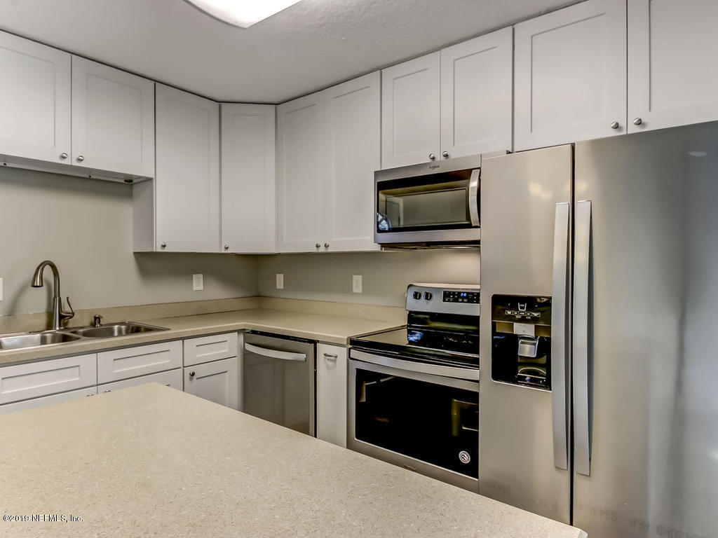 2165 Tuskegee Road Jacksonville, FL 32209 - Photo 9 of 32 a kitchen with cabinets stainless steel appliances and a sink