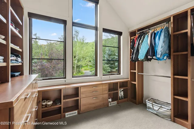 a kitchen with a refrigerator and white cabinets