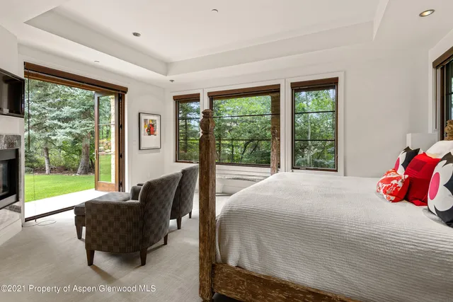 a bedroom with a bed and a large window