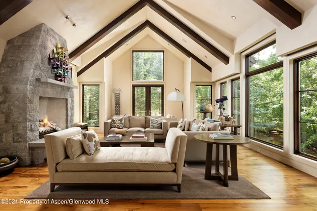 a living room with furniture and large windows