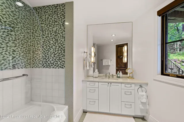 a bathroom with a sink a vanity and a mirror