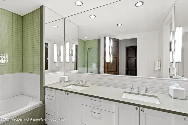 a bathroom with a double vanity sink and a mirror
