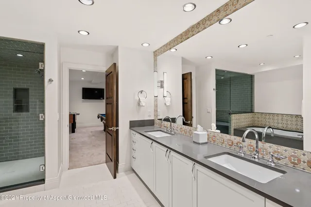 a spacious bathroom with a granite countertop sink mirror and shower