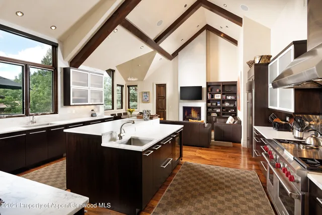 a large kitchen with stainless steel appliances granite countertop a sink and a stove