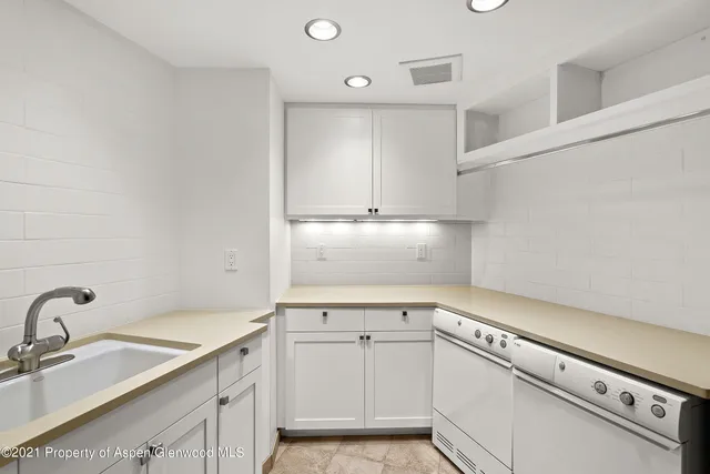 a view of cabinets a sink and dishwasher in a kitchen