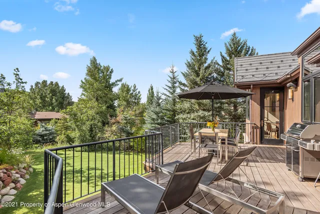 a view of a patio with couches table and chairs and potted plants