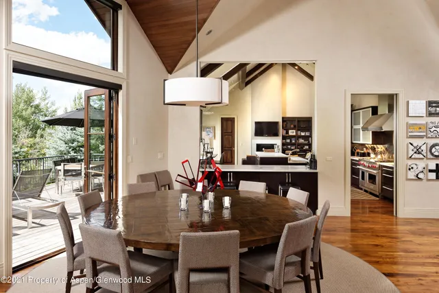 a dining room with furniture window and wooden floor