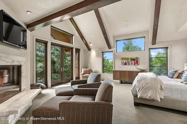a bedroom with furniture and a large window