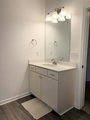 a living room with a bed and a flat screen tv