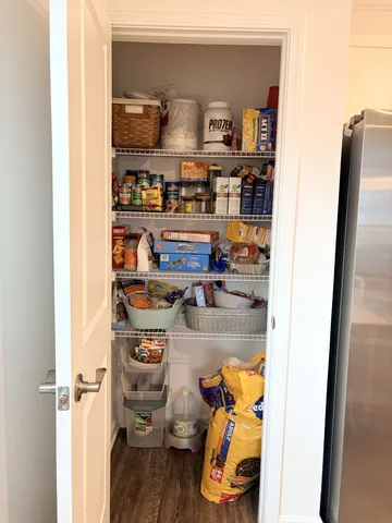 a living room with granite countertop furniture and kitchen view