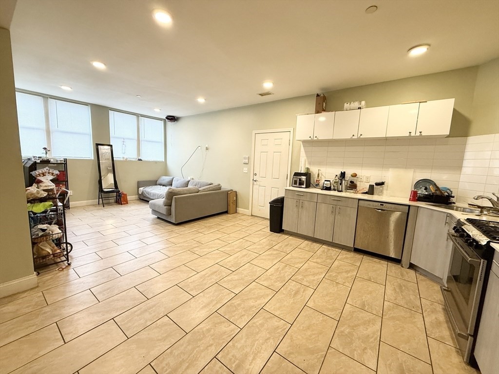299 Dudley Street, Unit 1 Boston, MA 02119 - Photo 1 of 10 a large room with kitchen view