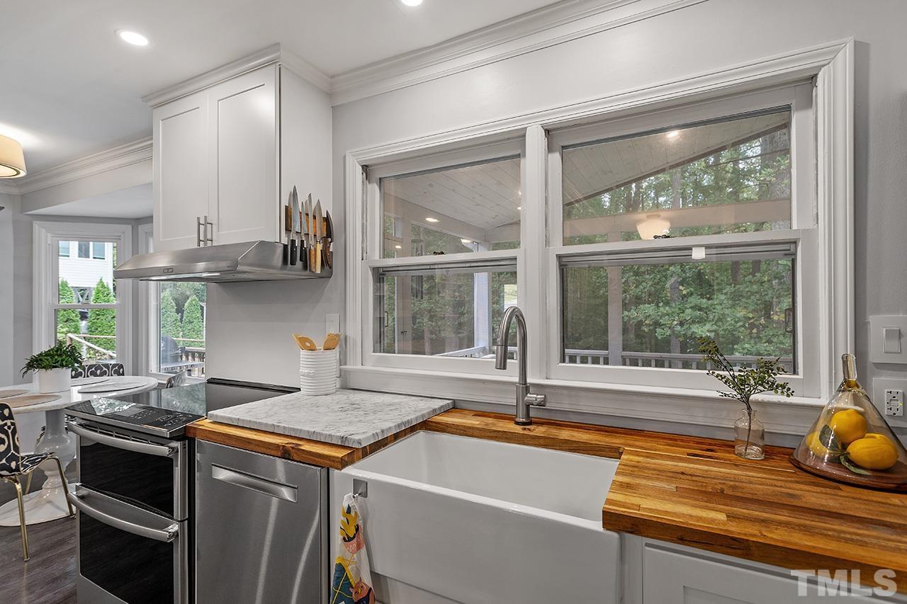 6236 Rushingbrook Drive Raleigh, NC 27612 - Photo 9 of 36 a kitchen with a sink and a stove top oven