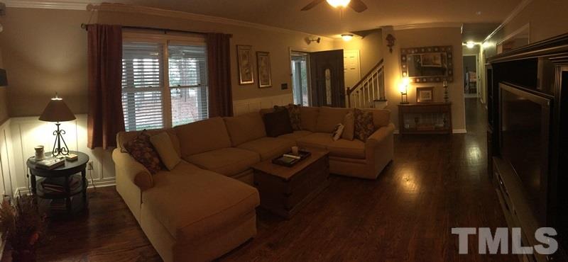 12005 Shooting Club Road Raleigh, NC 27613 - Photo 12 of 25 a living room with furniture and a fireplace