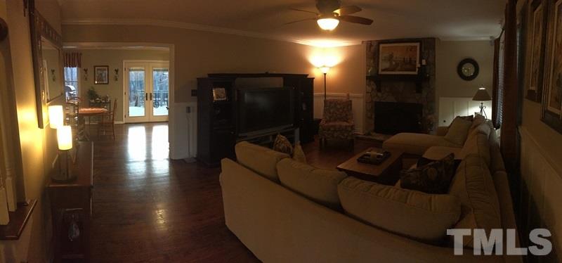 12005 Shooting Club Road Raleigh, NC 27613 - Photo 13 of 25 a living room with furniture and a flat screen tv