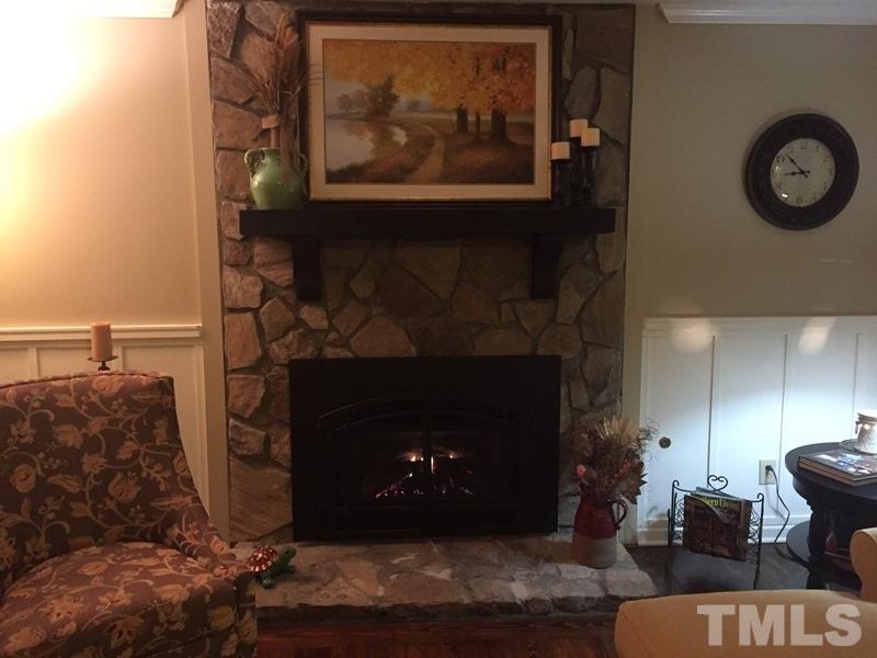 12005 Shooting Club Road Raleigh, NC 27613 - Photo 14 of 25 a living room with furniture and a fireplace