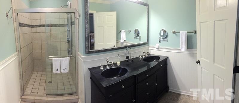 12005 Shooting Club Road Raleigh, NC 27613 - Photo 16 of 25 a bathroom with a sink vanity granite and a mirror