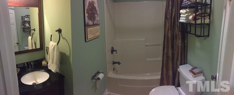 12005 Shooting Club Road Raleigh, NC 27613 - Photo 19 of 25 a bathroom with a granite countertop sink toilet and shower
