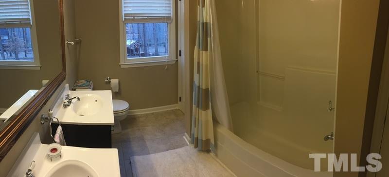 12005 Shooting Club Road Raleigh, NC 27613 - Photo 20 of 25 a bathroom with a sink and a bathtub