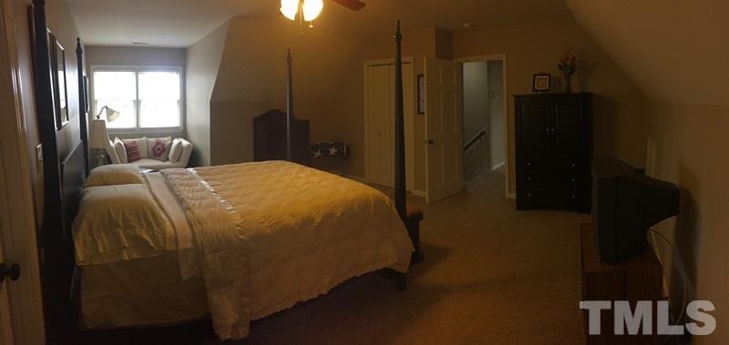 12005 Shooting Club Road Raleigh, NC 27613 - Photo 23 of 25 a bed sitting in a bedroom next to a window
