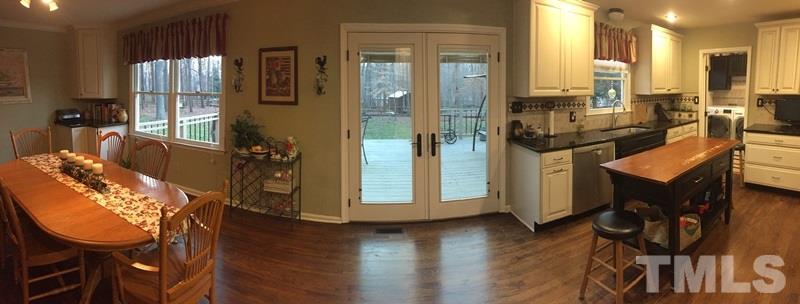 12005 Shooting Club Road Raleigh, NC 27613 - Photo 7 of 25 a view of a kitchen with dining table and chairs