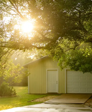 a view of a big yard with wooden fence