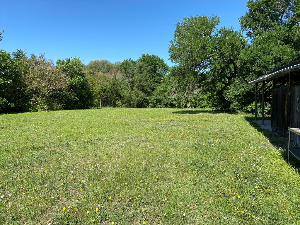 4902 Pecan Springs Road Austin, TX 78723 - Photo 16 of 17 a view of a field with trees in the background