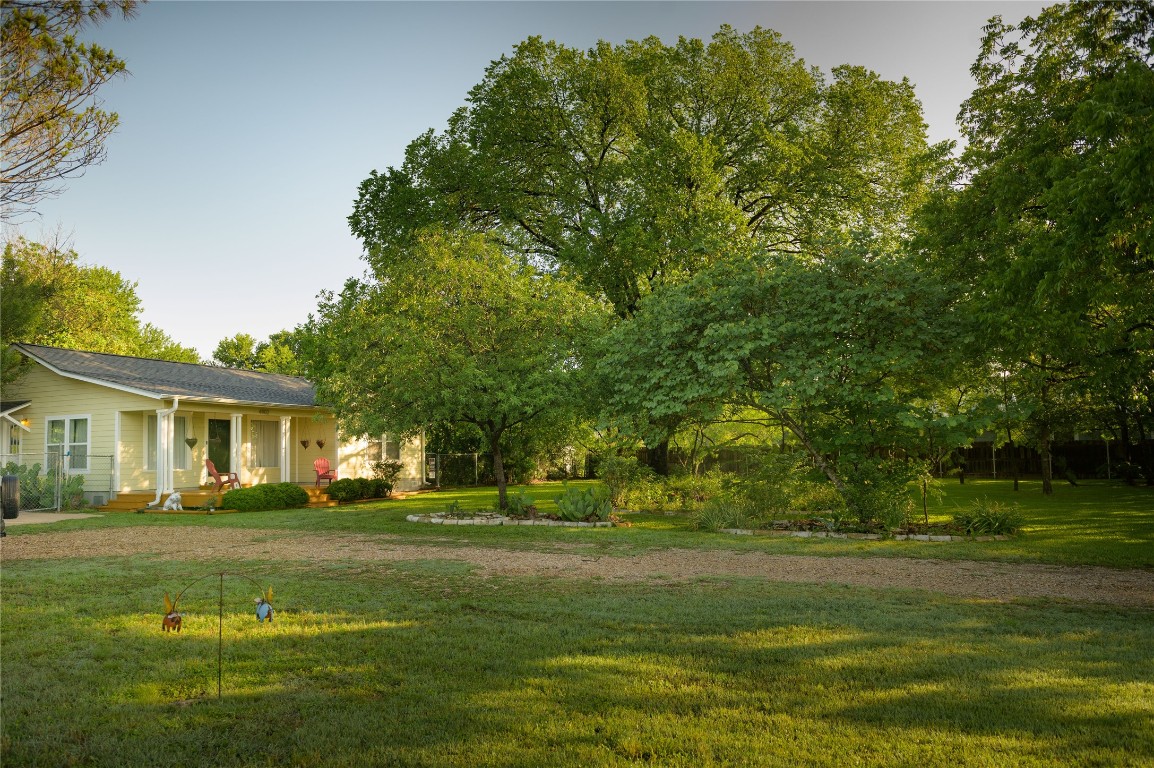 4902 Pecan Springs Road Austin, TX 78723 - Photo 6 of 17 a front view of a house with a garden