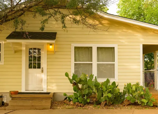a front view of a house having outdoor seating