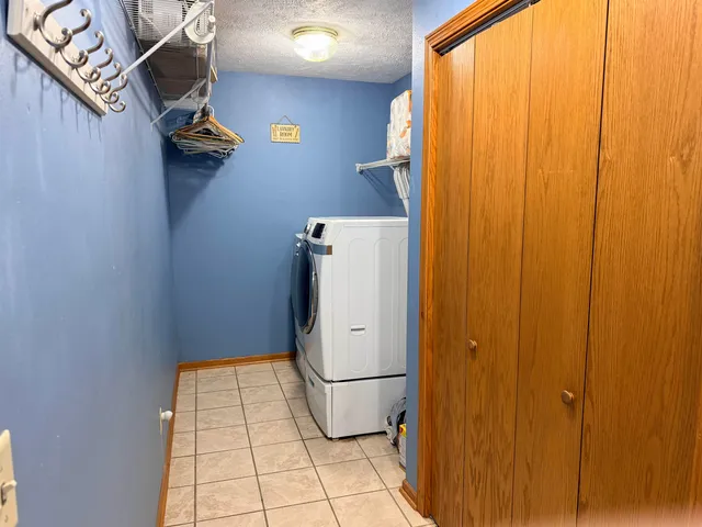a view of storage and utility room with a door