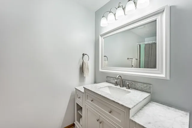 a bathroom with a sink vanity and a mirror