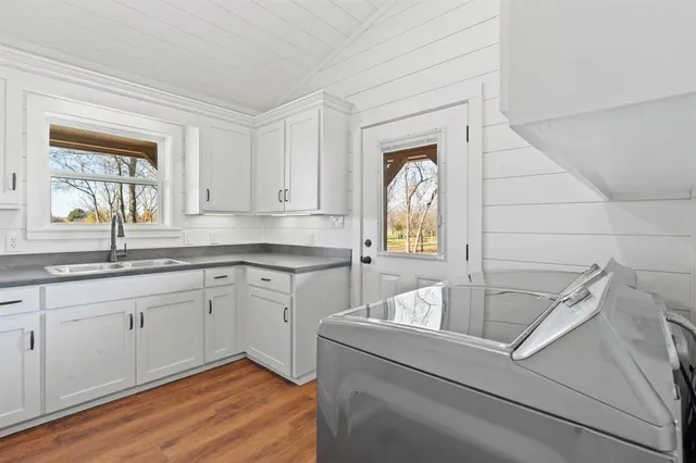 a kitchen with a sink cabinets and window