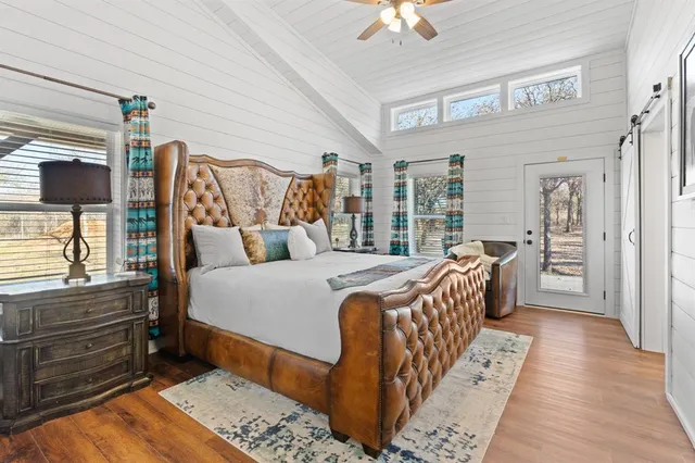 a bed sitting in a bedroom next to a window