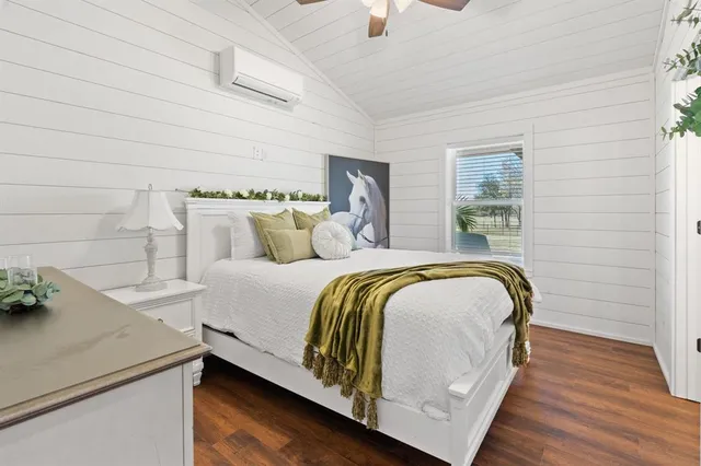 a bedroom with a bed and lamp