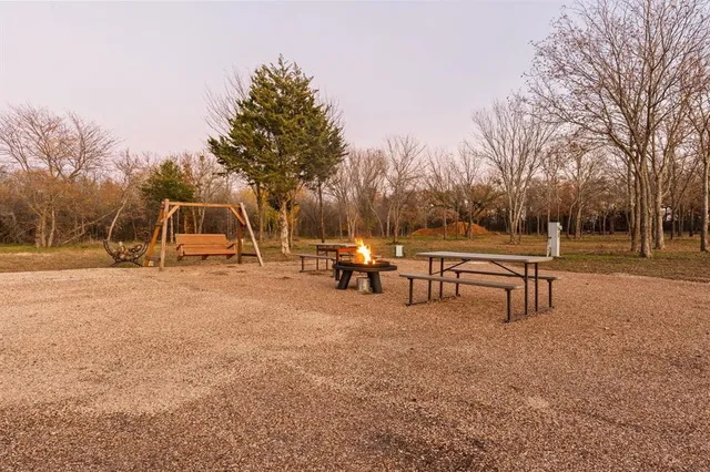 a view of bench with trees in the background