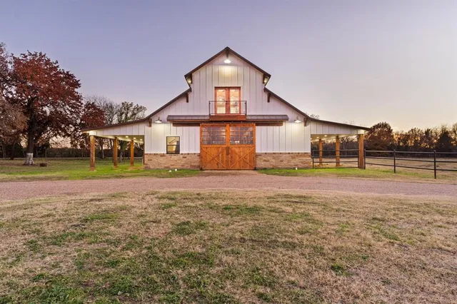 a view of a house with a yard and sitting area