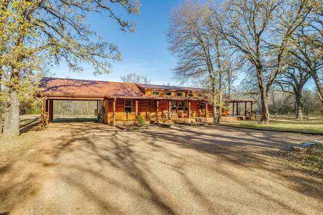 a view of a house with a yard and sitting area