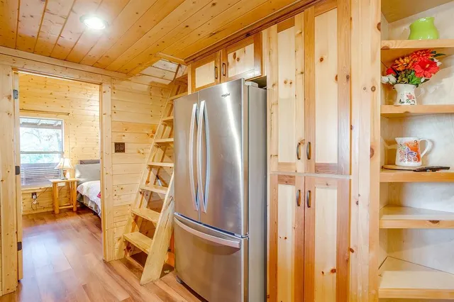 a metallic refrigerator freezer sitting inside of a room