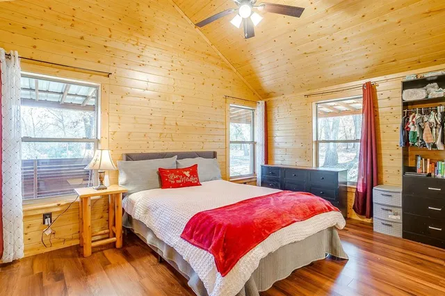 a bedroom with a bed and wooden floor