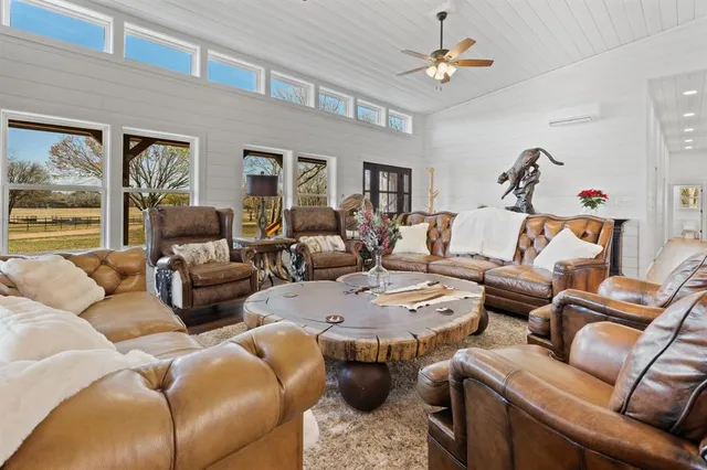 a living room with furniture a chandelier and a window